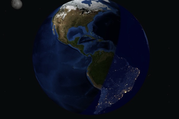 Earth from space at the day/night terminator, city lights glowing across nighttime South America.