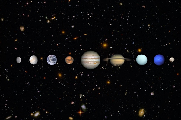 The eight planets and Pluto in a row across a deep field of distant galaxies, from Mercury to Pluto, with ringed Saturn near the center.